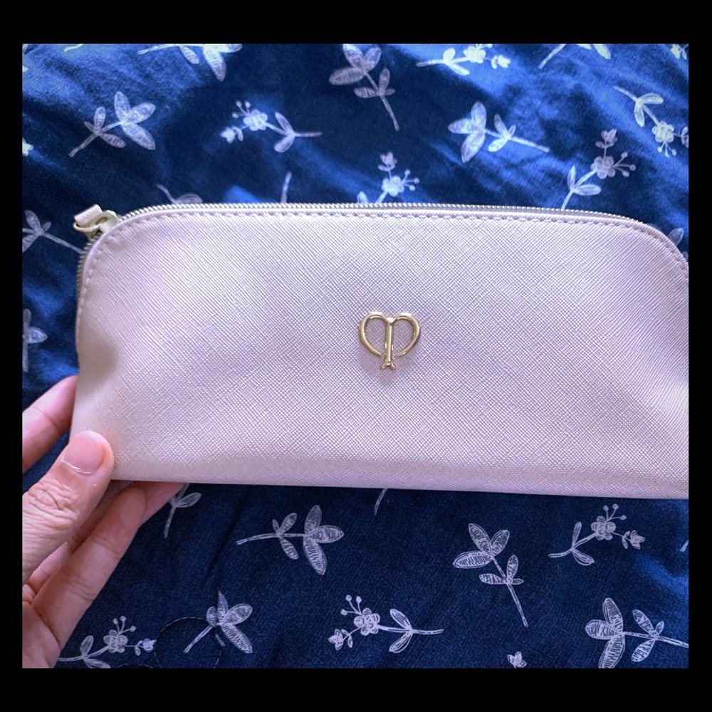 New Cle De Peau makeup bag in shiny cream color